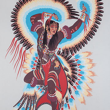 A Native American figure wearing feather wings and tail and beaded clothing depicted in a dance pose